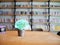 Illustration of watering can watering on brain in plant pot on wood table in library, education concept