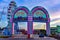 Iluminated entrance arches and colorful big wheel at Kissimmee Old Town in 192 Highway area .