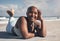 Im always in a better mood after a yoga session. a sporty young woman lying on her yoga mat at the beach.