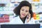 Im calling to confirm your prescription...a young woman using a computer and mobile phone at the counter of a pharmacy.