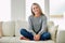 Im comfy on my couch. Full length portrait of an attractive young woman sitting on the sofa at home.