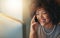 Im logging off now, Ill see you at home. a young woman talking on the phone during a late shift at the office.