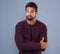 Im not sure what to tell you. Studio shot of a handsome young man looking uncomfortable against a gray background.