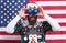 Im watching you. Bearded man look through funny eye glasses. Funny sight. Funny Santa on stars and stripes background