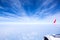 Image of Airplane seat next to window with white cloud and blue sky, Look through Aircraft window