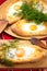 An image of an Ajarian khachapuri on table with raw egg close up