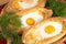 An image of an Ajarian khachapuri on table with raw egg close up