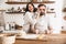 Image of amusing couple having fun together while making homemade pasta in kitchen at home