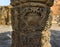 Image of a ancient sculptured pillar in a historical building in India