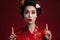 Image of asian geisha woman in japanese kimono pointing finger upward