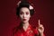 Image of asian geisha woman in japanese kimono pointing finger upward