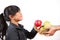 The image of an Asian girl holding red and green apples in an apple basket. Healthy and good for the diet. White background