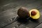 Image of avocado on black wooden background with copyspace