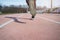 Image from back of legs of athlete running through stadium