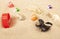 Image of battery plastic garbage seashell sand background