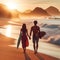 image of a beachcomber walking down a beach at sunset with waves breaking along.