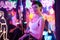 Image of a beautiful girl in an amusement park in a room with neon light. Entertainment concept