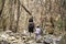 The image behind Mother shakes hands with son walking on a rock walkway Background dry tree at Phraya Nakhon Cave National Park ,