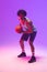 Image of biracial basketball player with basketball on neon purple background