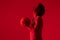 Image of biracial basketball player with basketball on neon red background