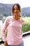 Image of biracial woman in pink long sleeve t shirt with copyspace in landscape background
