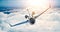 Image of black luxury generic design private jet flying in blue sky at sunset. Huge white clouds background. Business