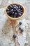 Image of blueberries in wooden bowl on rustic village table