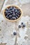 Image of blueberries in wooden bowl on rustic village table