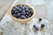 Image of blueberries in wooden bowl on rustic village table