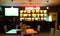 Image is blurred in a bar or tavern. Abstract image of an alcoholic beverage shop or pub. Colorful lighting in a store selling bee