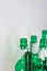 Image of the bottleneck of empty beer and wine green glass bottles on a white background. Reuse, acoholism, recycle and