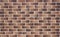 Image of brickwork with a transition of color from light brown to dark brown. Bavarian masonry.