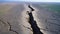 The image of the broken fault line stretching for kilometers of a very large earthquake in the agricultural area. Faults