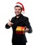 Image of brunet in Santa hat with gift in his hands