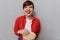 Image of brunette woman smiling and holding bucket with popcorn