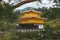 Image of a building with a Japanese architectural exterior on the water surrounded with nature.