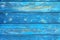 Image of bumpy vintage wooden background painted with blue paint