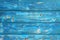 Image of bumpy vintage wooden background painted with blue paint