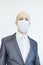 Image of business man wearing anti bacterial mask against virus and pollution