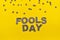 Image caption Fools' Day of carved paper letters of grey on a yellow background with grey confetti on the top edge