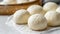 This image captures a group of fresh, white steamed buns, known as baozi