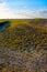 This image captures the stark beauty of a landscape with a dry pond, exposing the cracked and arid ground