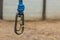 Image of a carabine hooks with blue climbing ropes hanging down.