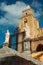 Image of the Cathedral of Cefalu, Sicily, Italy, featuring two statues at the entrance