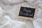 Image of chalkboard with text: HAPPY WEEKEND over cozy and white blanket. Top view.