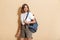 Image of charming teen girl carrying backpack smiling and walking
