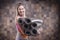 Image of a cheerful adult woman carrying a stack of rolled exercise mats. Yoga and pilates concept. Training, dancing and posing