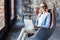 Image of cheerful office woman with blond hair in business wear sitting on chair and working with laptop office.