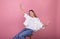 Image of a cheerful teenage girl on a pink background