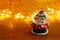 Image of christmas glass ball with snowman in front of gold glitter background